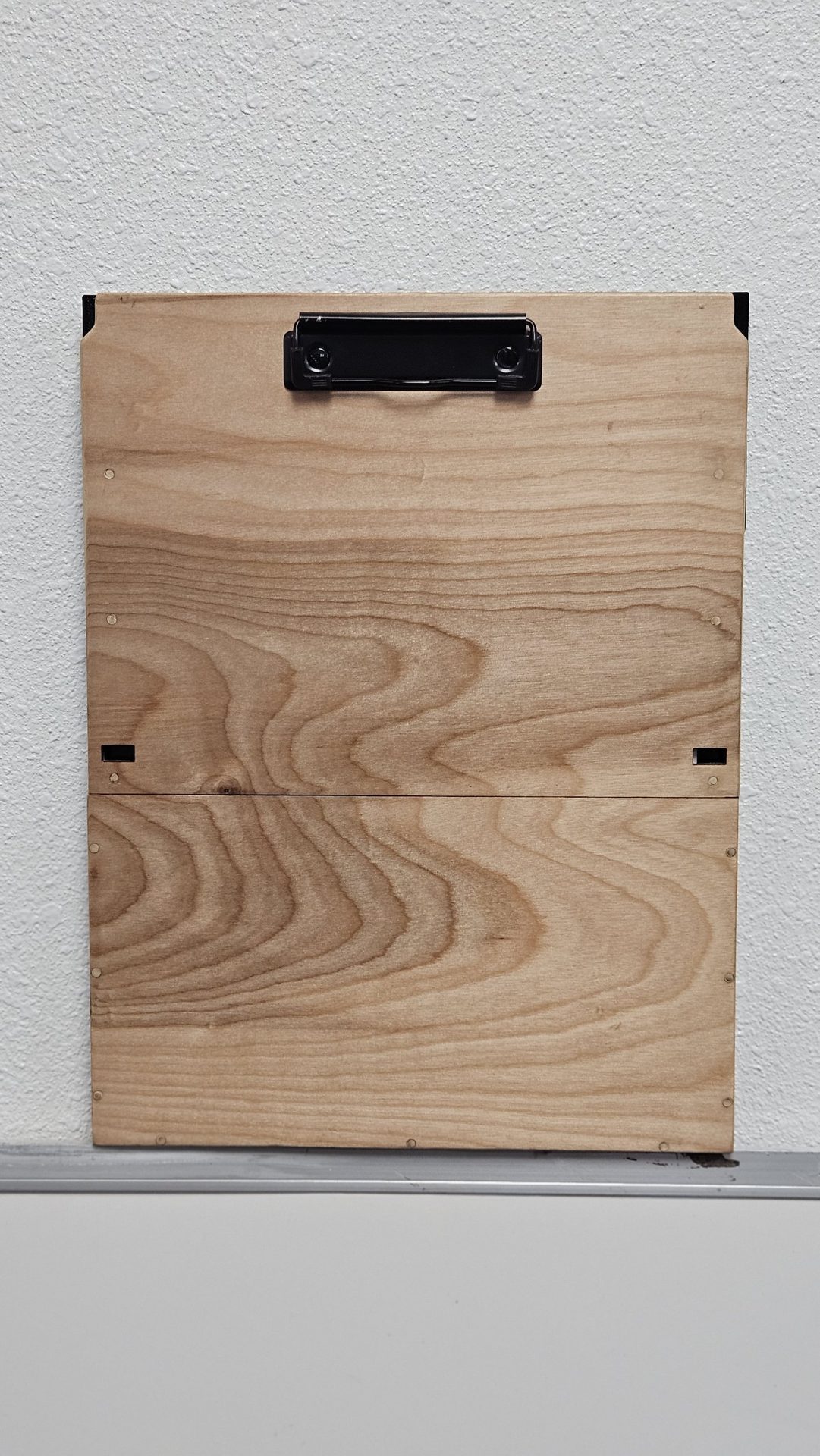 Studio photo of the DeskDrive Pro birch board front with metal clip