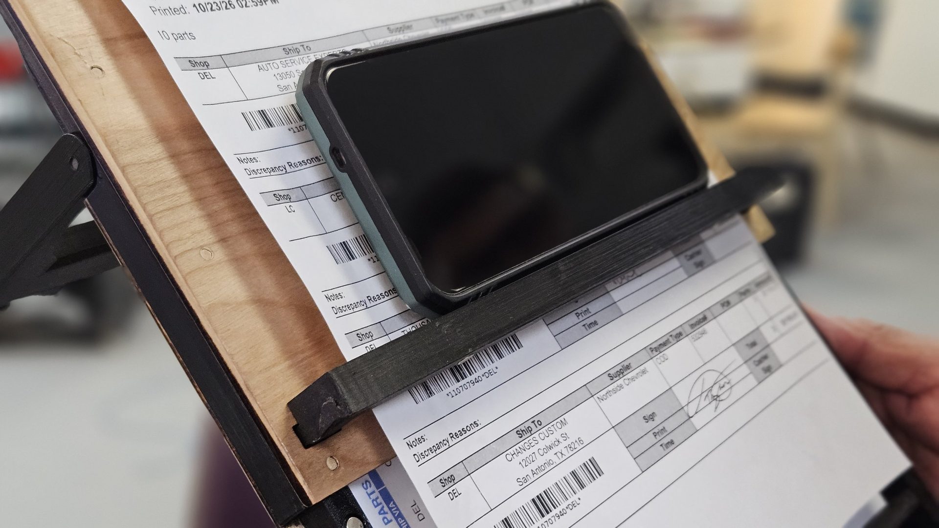 Close-up of the removable phone bar clipped across the front of the board
